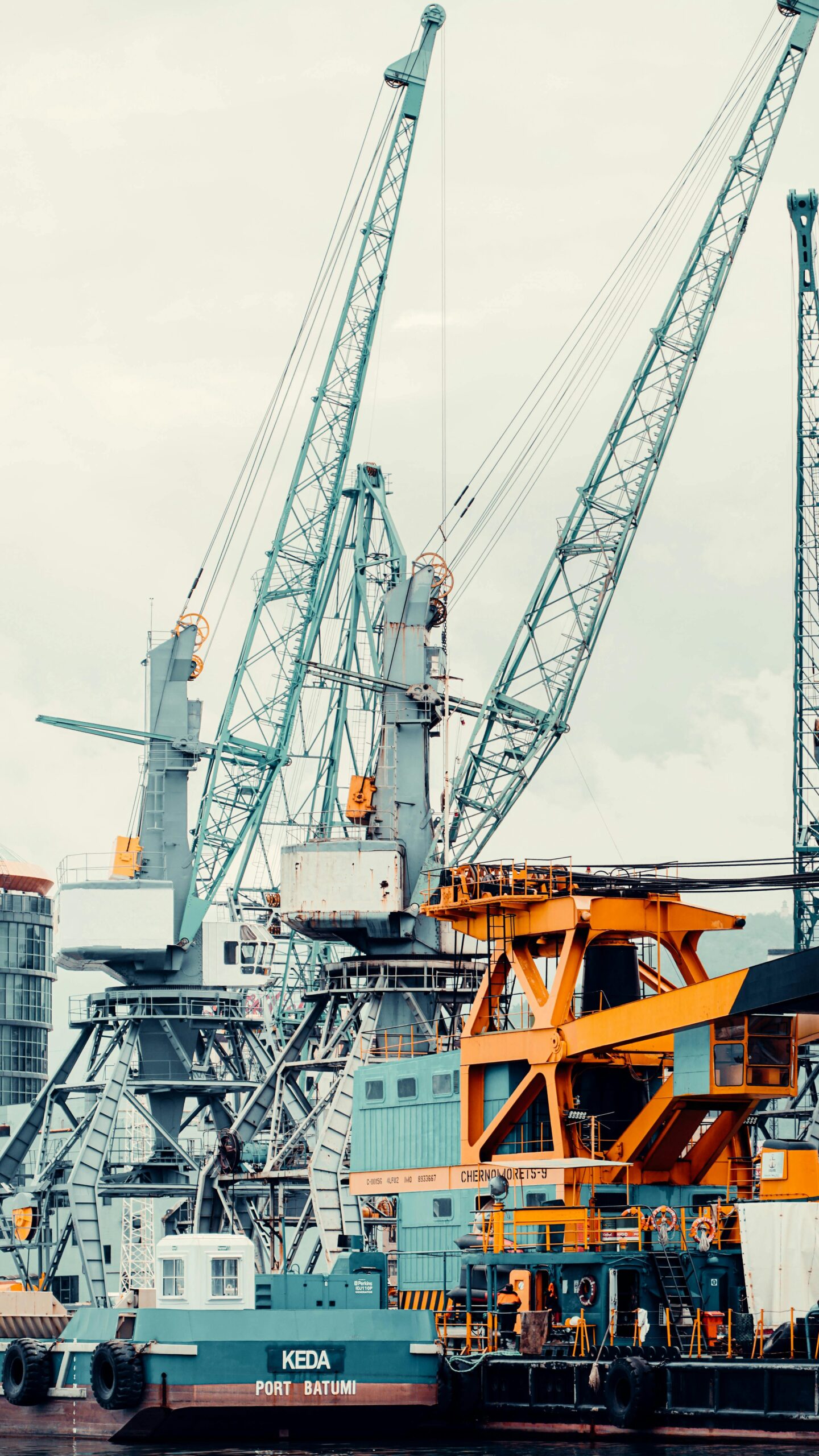 View of towering cranes and machinery at Batumi port, highlighting industrial activity.